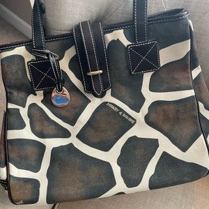 Giraffe print Dooney and Bourke bag. Cloth. Pink inside. Size- Approx. 14x10